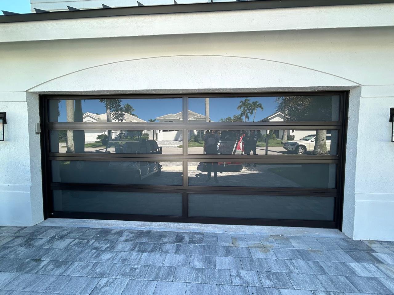 16x9 impact glass garage door with modern black frame and horizontal lites